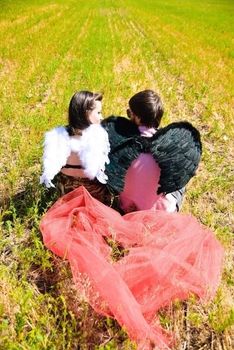 Young happy couple on the field. Shoot on the nature.