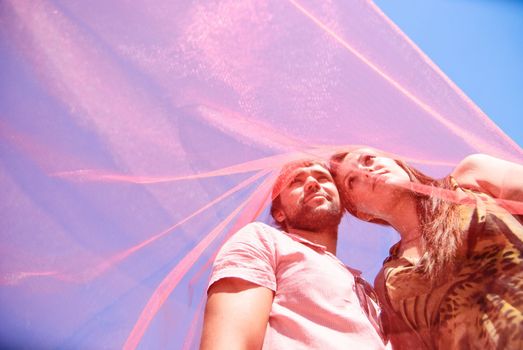 Young happy couple on the field. Shoot on the nature.
