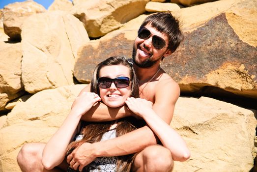 Young happy couple on the rocks. Shoot on the nature.