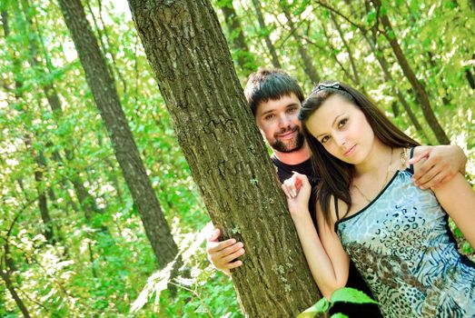 Young happy couple in the forest. Shoot on the nature.