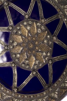 Close up view of a blue decorative morocco dish isolated on a white background.