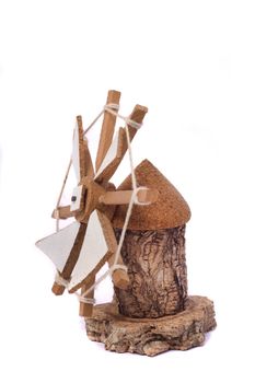 Close up view of a traditional handcraft windmill made of cork isolated on a white background. 