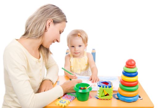 Baby girl drawing with her mother over white