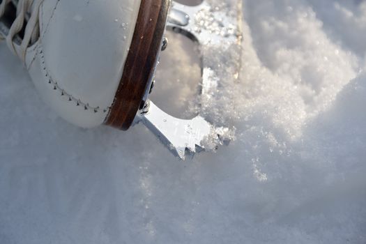 Close up of ice skating shoe at frozen lake in austria.