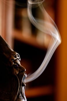 Close up view of a smoking doll with smoke.