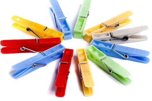 Close up view of some colorful cloth pegs isolated on a white background.