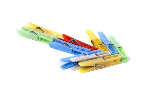 Close up view of some colorful cloth pegs isolated on a white background.