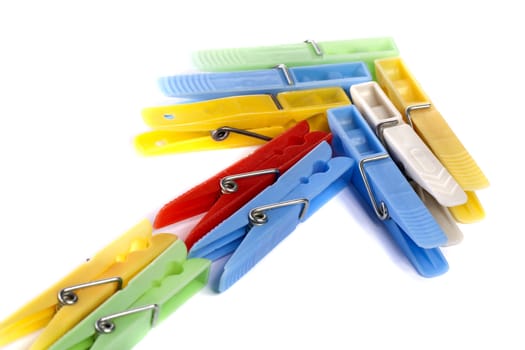 Close up view of some colorful cloth pegs isolated on a white background.
