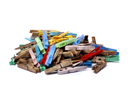 Close up view of some colorful cloth pegs isolated on a white background.