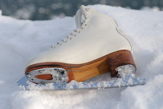 Close up of ice skating shoe at frozen lake in austria.
