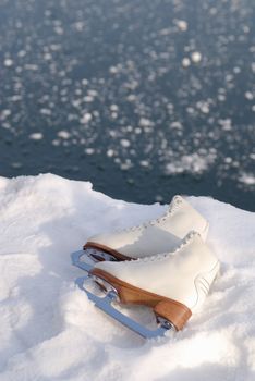 Close up of ice skating shoe at frozen lake in austria.
