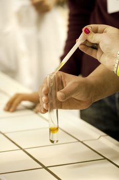 Close view of a chemistry student making an experiment.