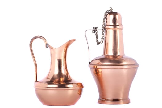 View of two old water recipients made of copper isolated on a white background.