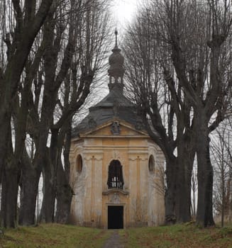 old avenue with ancient ruins of chapel