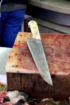 View of a bloody knife and stand at the fish market.
