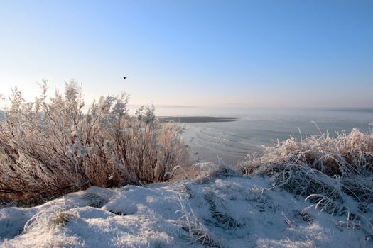 a seasonal snow covered view of atlantic ocean and ballybunion beach on a frosty snow covered winters day