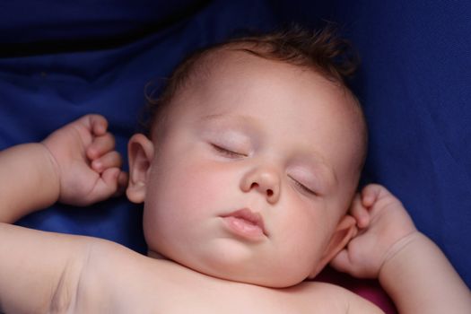 sweet little boy sleeps in a blue stroller