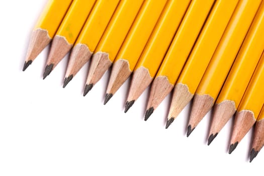 Close up view of a bunch of yellow pencils isolated on a white background.