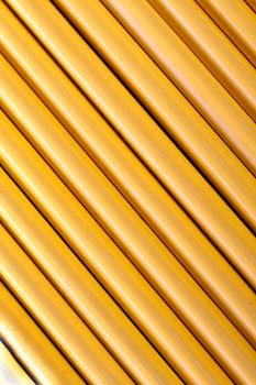 Close up view of a bunch of yellow pencils isolated on a white background.