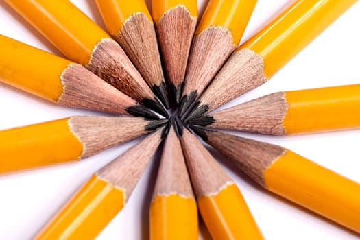 Close up view of a bunch of yellow pencils isolated on a white background.