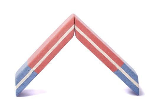 Close up view of a blue and red eraser isolated on a white background.