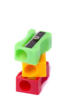 Close up view of three pencil sharpeners isolated on a white background.