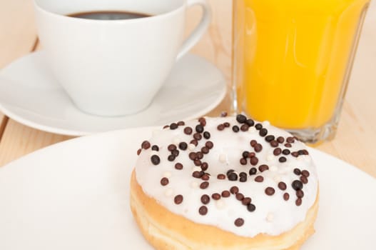 Breakfast - Donut, Coffee and Orange Juice on Wooden Table