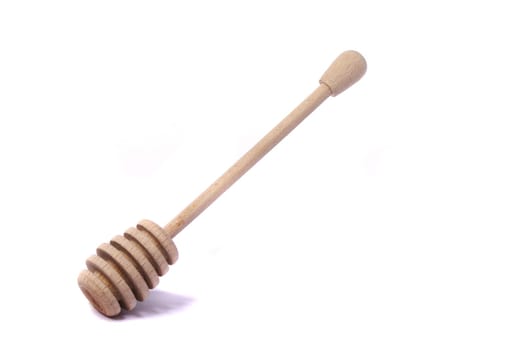 Close up view of a honey dipper utensil isolated on a white background.