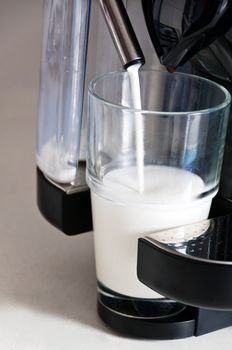 making a nice latte. steamed milk being poured
