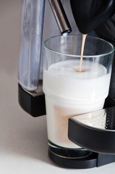 making a nice latte. cofee being poured on steamed milk