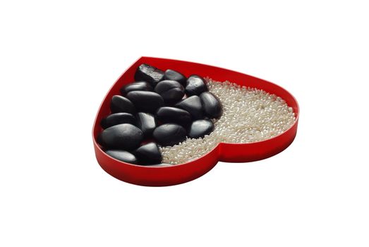 Red heart shaped tray filled in white beads and black stones in yin yang shape
