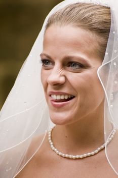 Close up portrait of attractive young bride happy and smiling naturally