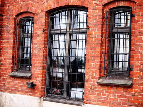 Old red brick building with steel fence