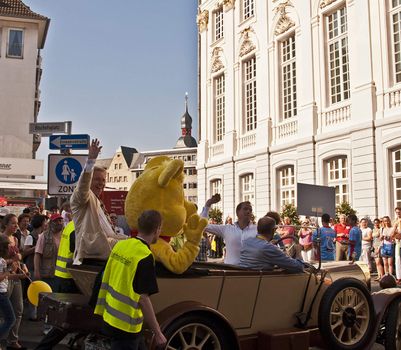 Day of German Unity, festive parade, photo taken in Bonn on the 3 of October 2011. Thomas  Gottschalk , German TV host, laughing and greeting the public. People, throwing sweets from the car in the crowd.