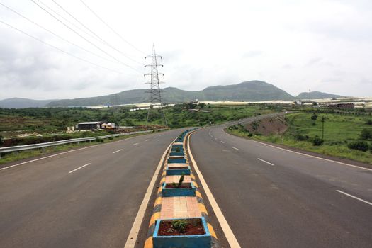 A long stretch of an empty highway in India.