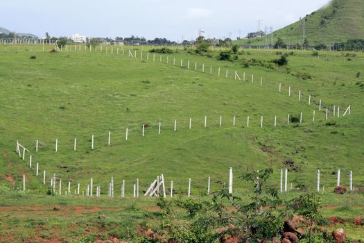 Fencing laid to mark empty plots on a landscape.