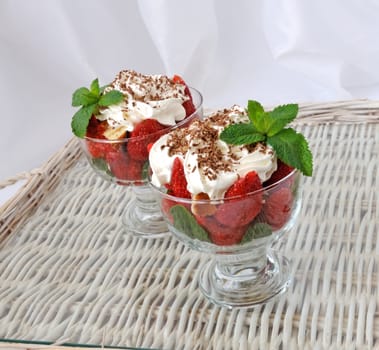 Strawberries with biscuit pieces with mint whipped cream with a grated chocolate