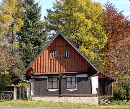 little mountain cottage in the autumn sun