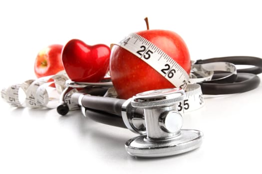 Stethoscope with red apples on a white background
