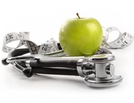 Green apple with stethoscope against white background