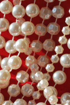 String of pearls over red background