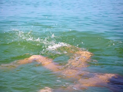 Girl in the sea under the water. Silhouette