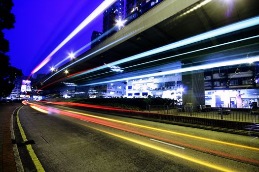 blurred bus light trails in downtown night-scape in hongkong.