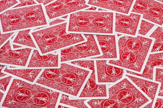 Close up view of a bunch of flipped playing cards spread on a green cloth table.