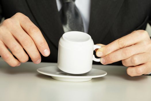 Businessman guesses on coffee grounds close up