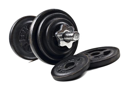 Black dumbbells and loose weights on a white background with space for text