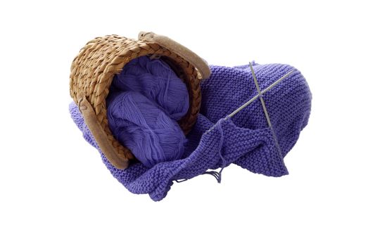 Lilac knitting in interwoven basket isolated on white background