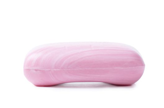 Closeup view of pink soap with white stripes on the white