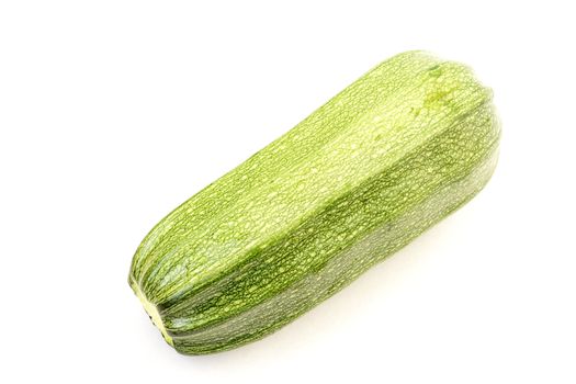 Single ripe green zucchini isolated on white background