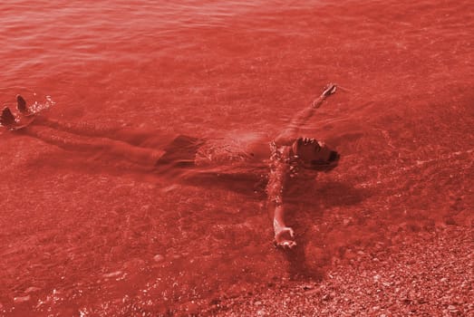 Portrait of a young vampire in the bloody sea